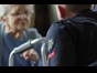 Firefighter talking to elderly person 