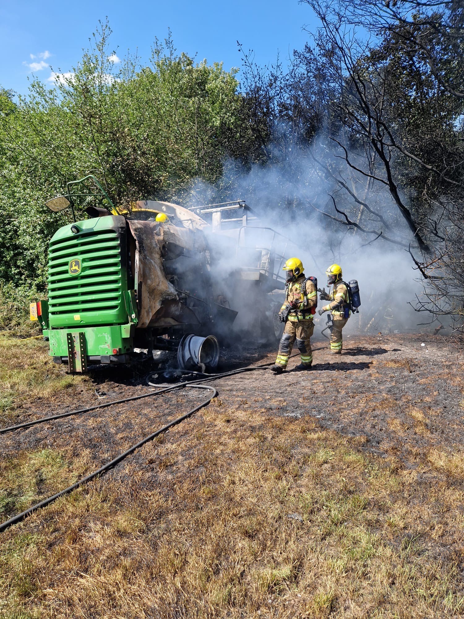 Two on-call firefighters extinguishing a vehicle fire