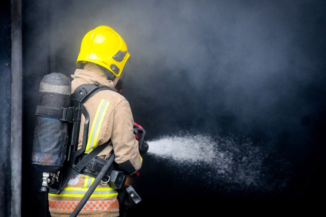 Firefighter extinguishing fire