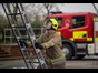 Firefighter climbing ladder