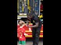Firefighter giving a Welephant club sticker to a young boy at a community event.